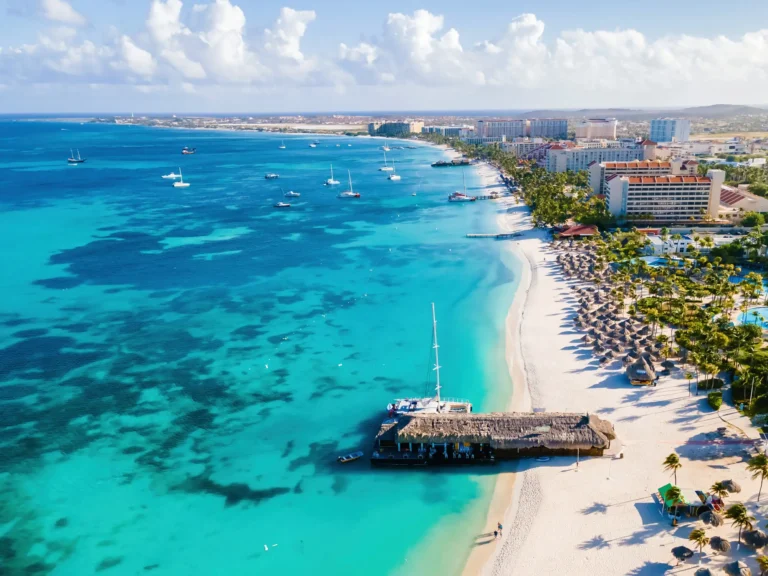 Palm Beach in Aruba, white sand and palapas